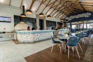 a restaurant with tables and chairs and a bar at 362@BallitoHills in Ballito