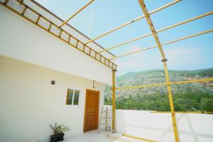 a glass house with a view of the mountains at Sri Govindham Home Stay in Tirupati