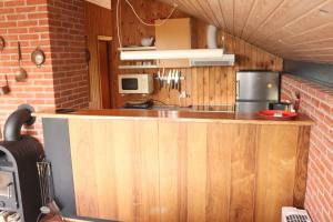 a kitchen with a wooden counter in a room at Summerhouse Near The Limfjord And The Western Sea in Vestervig