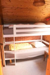 two bunk beds in a room with a wooden ceiling at Summerhouse Near The Limfjord And The Western Sea in Vestervig