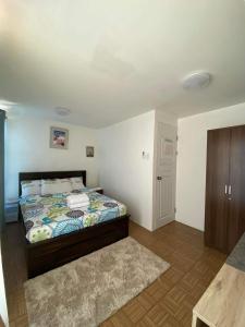 a bedroom with a bed and a wooden floor at Eve transient home in Davao City +8 photos