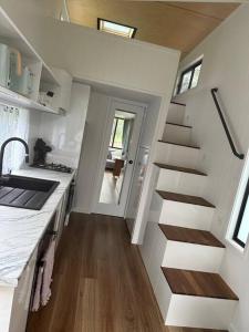 a stairway in a kitchen with a stair case at Tiny Home + Donkeys + Alpacas in Tamborine