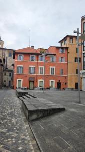a large brick building with benches in front of it at Piccolo Loft in Foligno