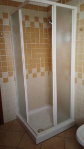 a shower with a glass door in a bathroom at Sa Ziminera in Senorbì +28 photos