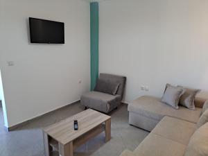 a living room with a couch and a coffee table at Dolphins House in Koinyra