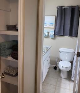 a bathroom with a toilet and a sink at Welcome to Cozy and Quiet Residence in Valdosta +16 photos