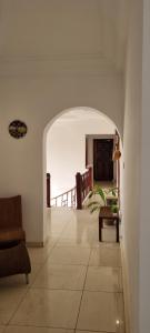 a room with an archway with a table and a balcony at HomeVilla in Tranquil