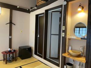 a bathroom with a sink and a large glass door at Roman Kan in Kyoto +79 photos
