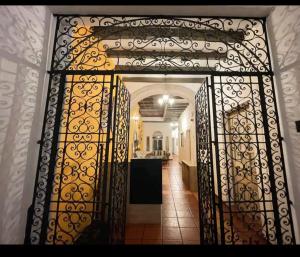 an open gate to a hallway with a kitchen at Room 3 for 2 People, Double Bed in Morelia +2 photos