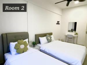 2 letti posti uno accanto all'altro in una camera da letto di The Urban Lodge 2 a Kuala Terengganu