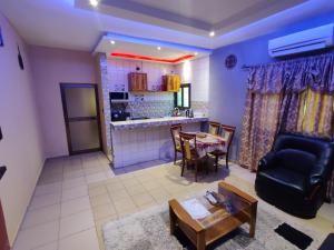 a living room with a couch and a table at RÉSIDENCE VICTORIA in Lomé