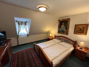 a bedroom with a bed and a television in it at Hotel Razgorsek in Velenje
