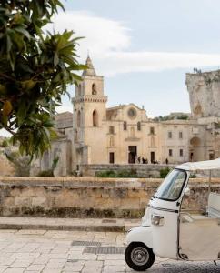 a small car parked in front of a building at Martini Matera 2-luxury apartment in Matera