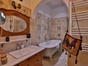 a bathroom with a sink and a bath tub and a sink at Dar Souad in La Marsa