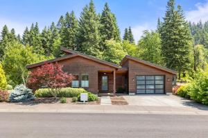 a home in the woods with a driveway at Hummingbird in Cascade Locks