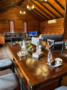 a large wooden table in a room with a couch at Tola Holiday House Al Rimal in Riyadh