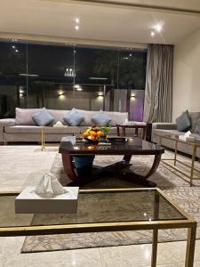 a living room with a table with fruit on it at Tola Holiday House Al Rimal in Riyadh