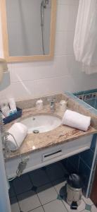 a bathroom counter with a sink and a mirror at Le Querrien in Cancale