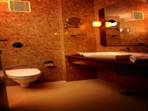 een badkamer met een toilet en een wastafel bij SUNFLOWER HOTEL in Mysore