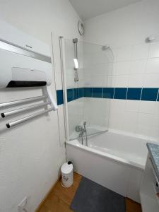 a small bathroom with a tub and a shower at Puy St Vincent 1800 au pied des pistes in Puy-Saint-Vincent +42 photos