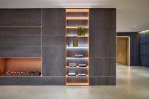 a living room with a wall of shelves at Four Points by Sheraton Venice Mestre in Mestre