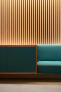 a blue couch in front of a wooden wall at Four Points by Sheraton Venice Mestre in Mestre