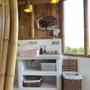 a bathroom with a sink and a mirror at Camanta Penida - Adult Only in Nusa Penida