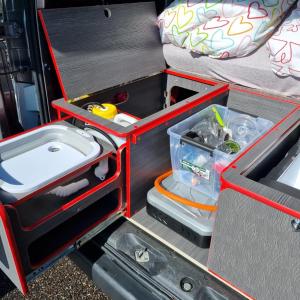 an open drawer in the back of a van at Electric Minicamper blue in Askøy