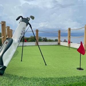 a golf swing on the grass with red flags at Camanta Penida - Adult Only in Nusa Penida