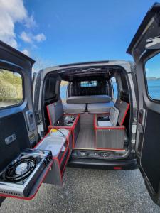 an open back seat of a van with the trunk open at Electric Minicamper blue in Askøy