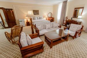 a living room with a bed and a couch and chairs at Hotel Grand Samarkand Superior - B in Samarkand +45 photos