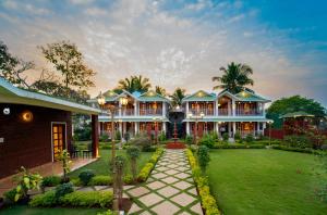 an exterior view of a house with a lawn at Coconut Greenland Resort in Nagaon