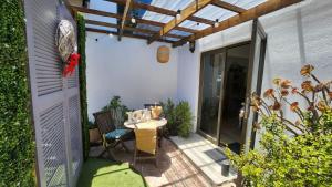 un patio al aire libre con una mesa y una pérgola en Harbour Delight & Harbour Comfort, en Ciudad del Cabo