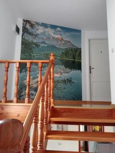 a mural of a mountain on a wall next to a staircase at Casa Popa in Gura Humorului