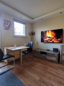 a living room with a table and a fireplace at Apartament pod szczęśliwą 13 in Toruń