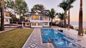 a villa with a swimming pool and a house at Esperanza Villas by SVAR Stays in Panchgani +103 photos