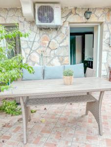 a bench sitting in front of a stone wall at Mistral Houses in Meganisi