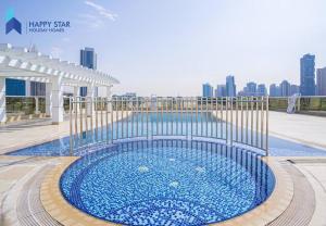 a swimming pool with blue water in a building at Luxurious 2BR Apartment near Palm Jumeirah in Dubai