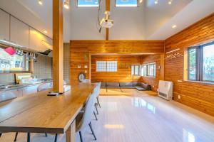 Private hot-spring Villa in Kusatsu في كوساتسو: غرفة طعام مع طاولة وكراسي خشبية كبيرة