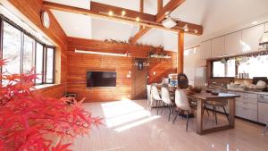 a kitchen and dining room with a table and chairs at Private hot-spring Villa in Kusatsu in Kusatsu