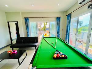 a living room with a pool table at Dream pool villa 2 in Ban Nong Chap Tao