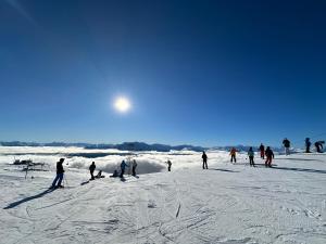 a group of people skiing on a snow covered slope at Sweet home in the heart of Davos in Davos