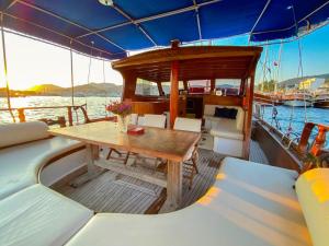 a wooden table on a boat in the water at Bodrum Private Boat Tours -Daily -Yacht Tours Bodrum in Bodrum City