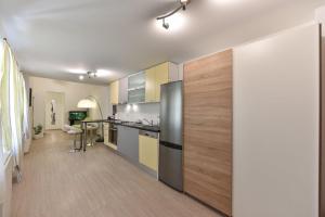 a kitchen with stainless steel appliances and wooden floors at Rooms Old Town in Zadar