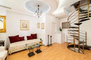 a living room with a couch and a spiral staircase at Traditional Vintage House Plaka, Athens Center in Athens