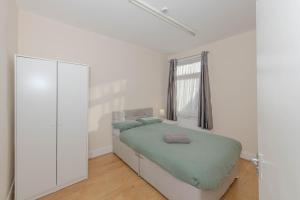 a bedroom with a bed and a large mirror at Cosy 4 bedrooms house near Central London, O2, London city airport and Excel in Plumstead