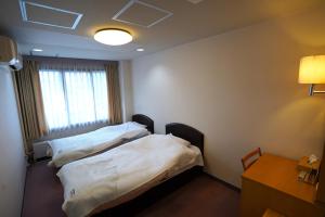 Postel nebo postele na pokoji v ubytování The Hakuba Station Room