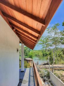 a wooden roof over a porch of a house at River Relax Villa in Ahangama