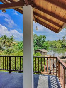 a porch with a view of a river at River Relax Villa in Ahangama