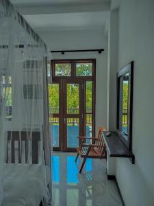 a room with a window and a bench and a mirror at River Relax Villa in Ahangama